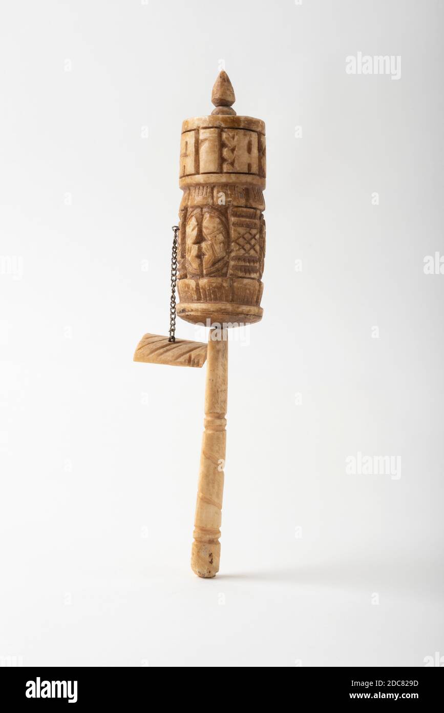 A prayer wheel from Bhutan made from a human femur; with carved inscriptions and icons from Buddhist ideology. Stock Photo