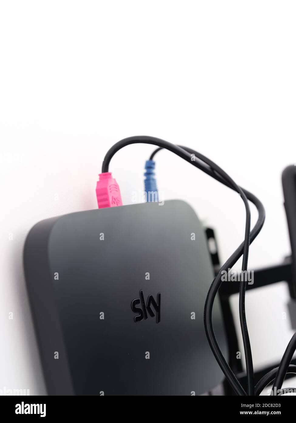 HDMI Wires pink and blue to Sky digital box and back of TV Stock
