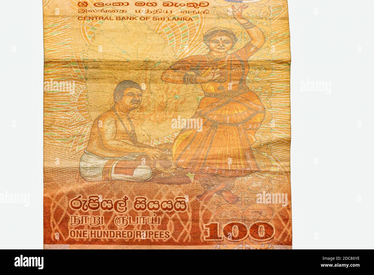 100 Sri Lankan rupee used bank note closeup on isolated white background with copy space. Rupees is the national currency of Sri Lanka. Stock Photo