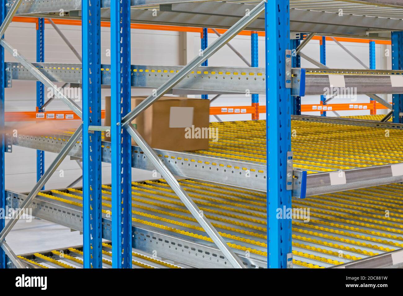 Gravity Flow Rack Shelving in Distribution Warehouse Stock Photo