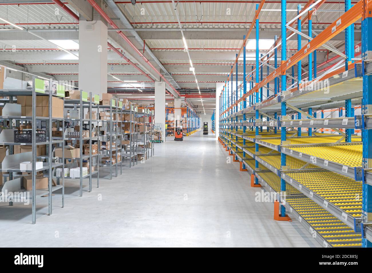 Gravity Flow Rack Shelving in Distribution Warehouse Stock Photo