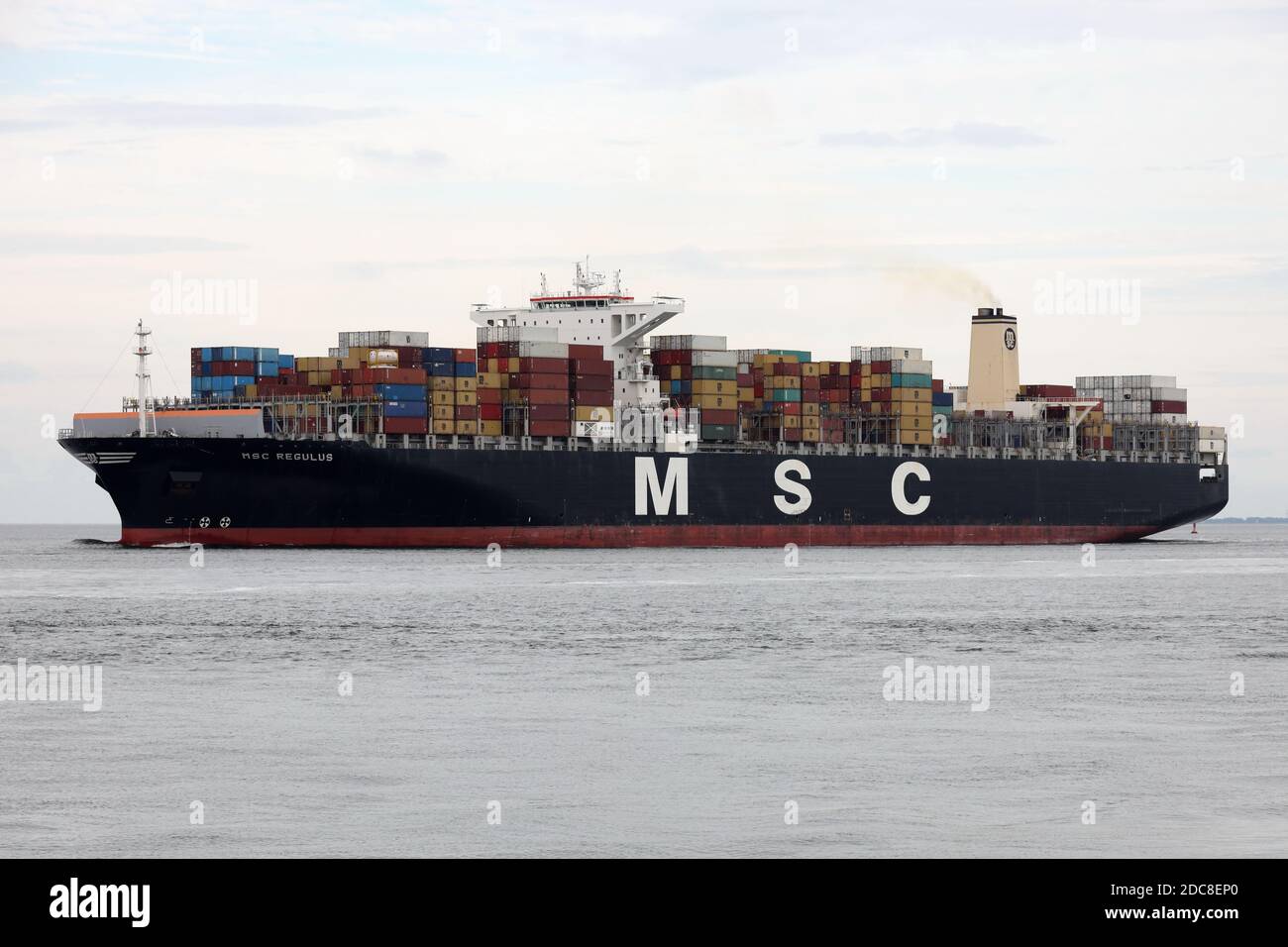 The container ship MSC Regulus will pass the city of Cuxhaven on the river Elbe on August 20, 2020 on its way to the North Sea. Stock Photo