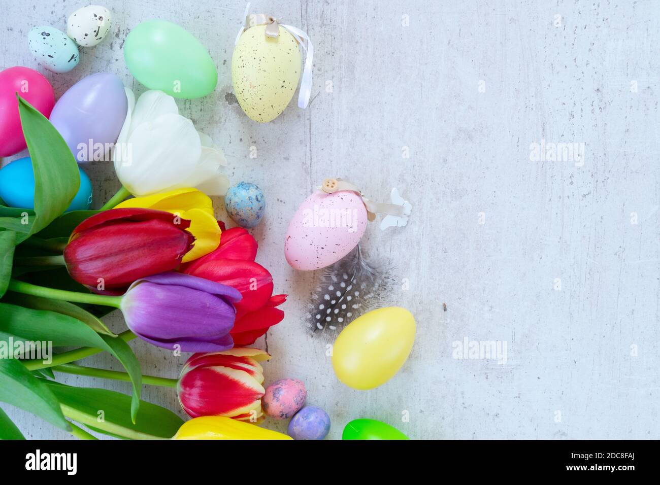 Easter colored eggs with tulips Stock Photo - Alamy