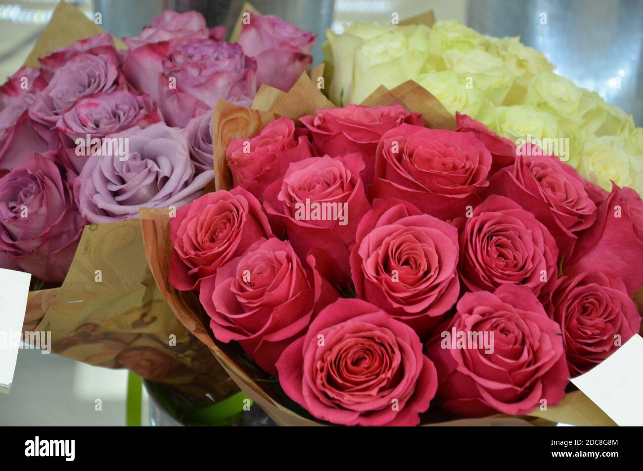 Beautiful bouquets of roses are presented in street flower shop Stock