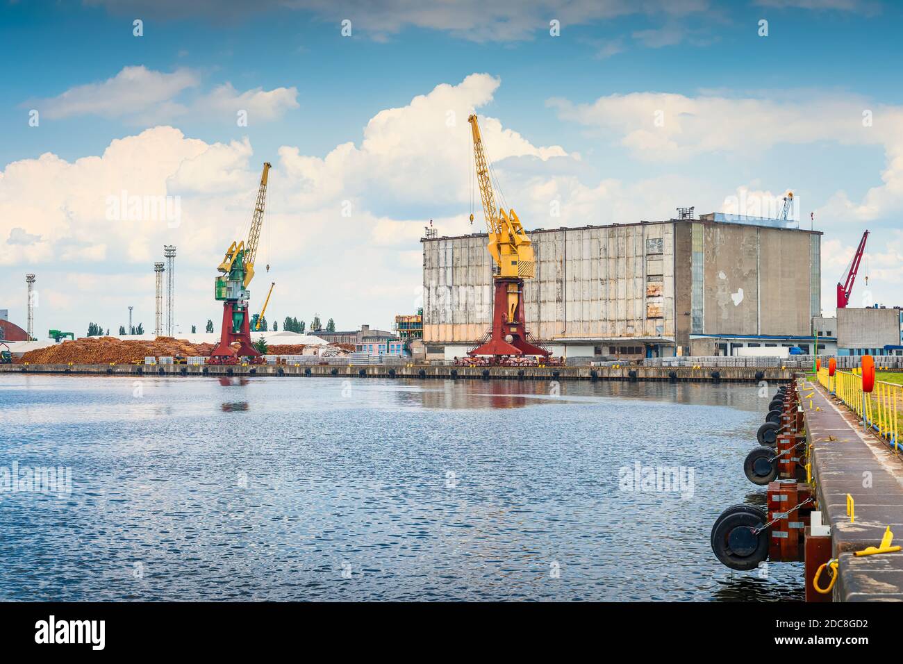 Cargo, industrial port and harbour in Szczecin with stacks of timer, tall  dock cranes and industrial machinery. West Pomeranian, Poland Stock Photo -  Alamy