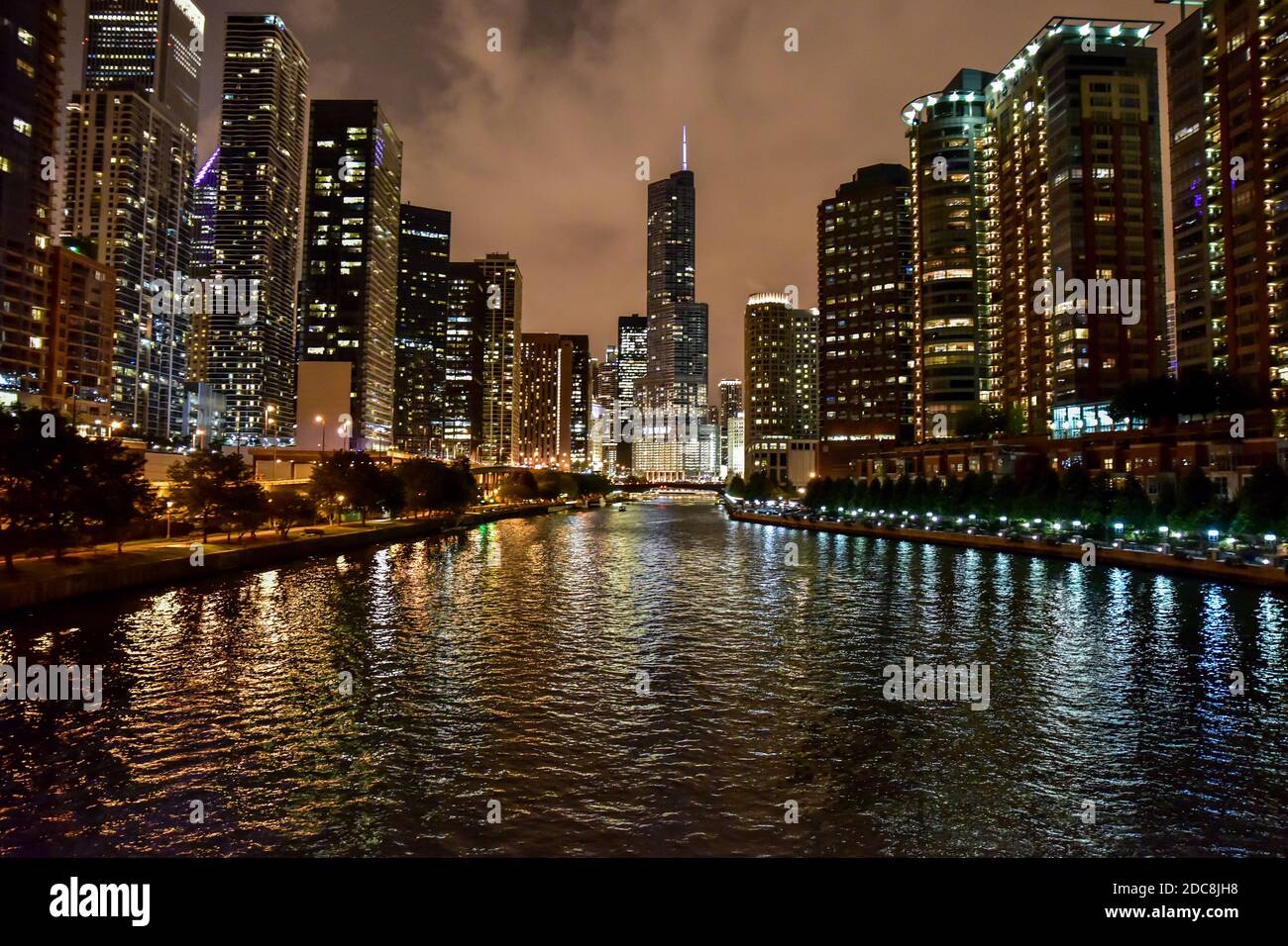 Big city skyline lights at night with river running through Stock Photo
