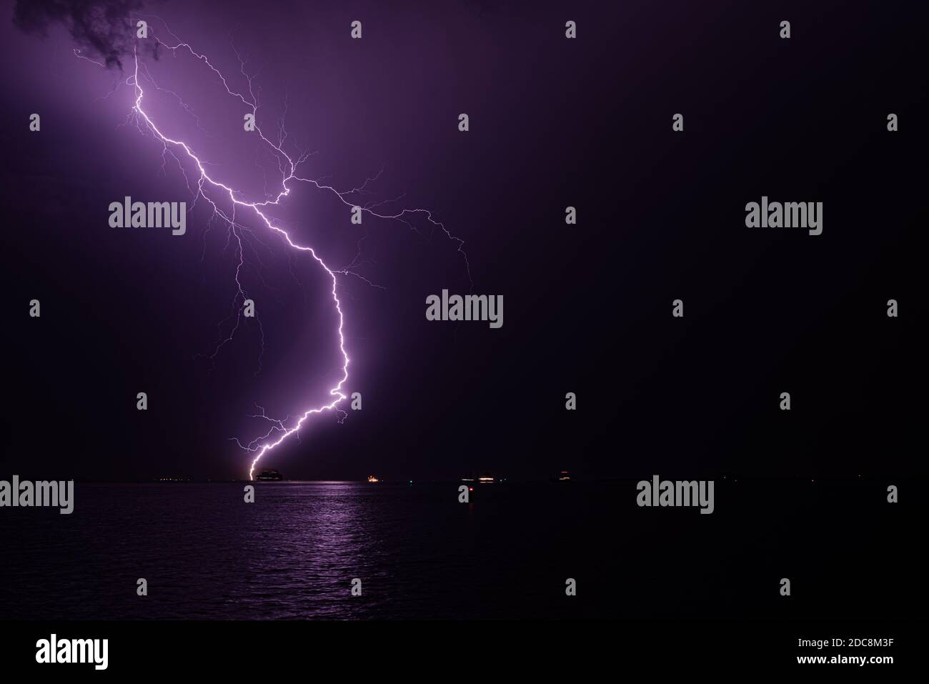 Lightning bolt hits the water during a severe thunderstorm Stock Photo Alamy