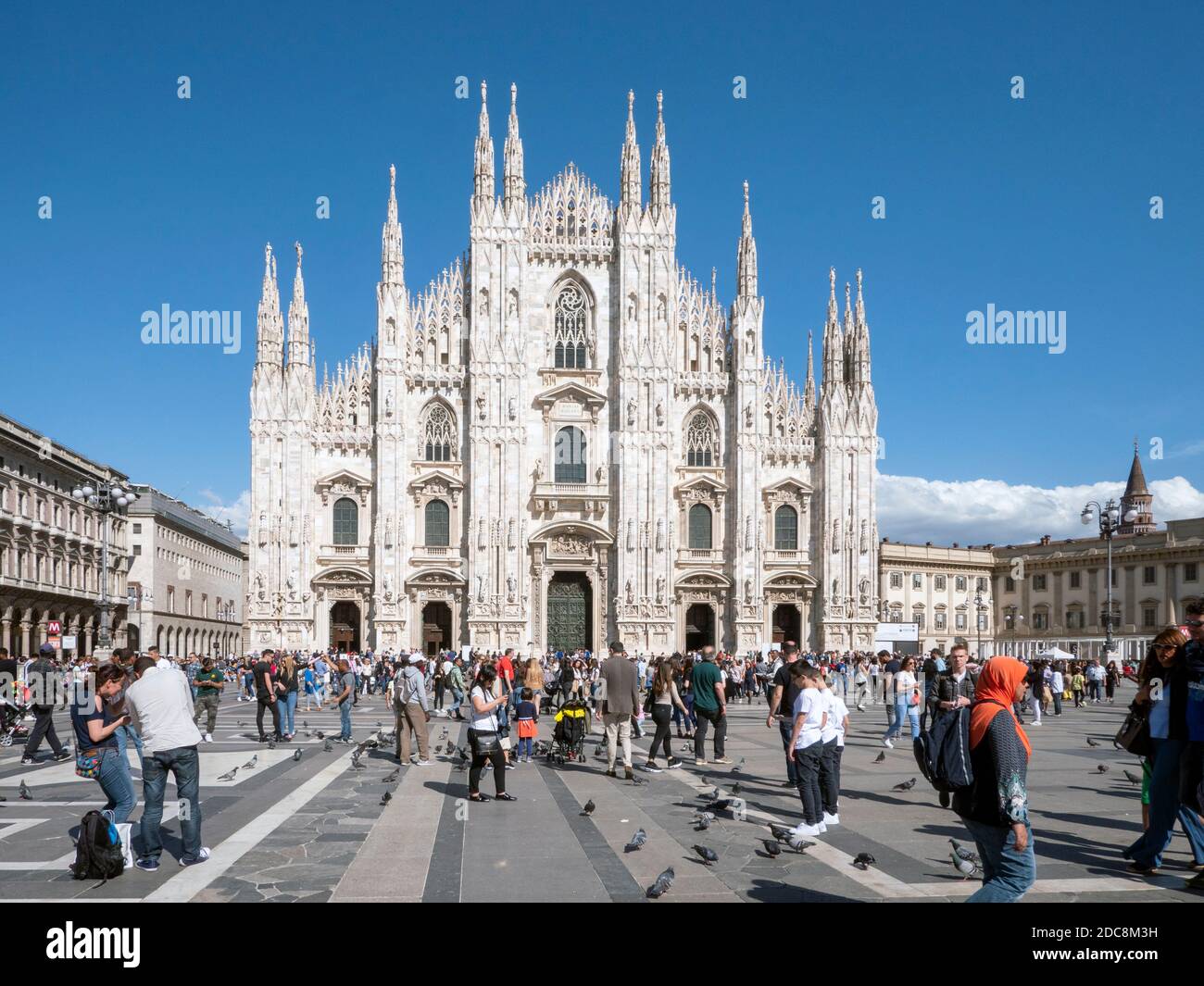 Crowds of tourists in front of the West Façade of Milan Cathedral  - Duomo di Santa Maria Nascentre - Milan, Lombardy, Italy, Europe. Stock Photo