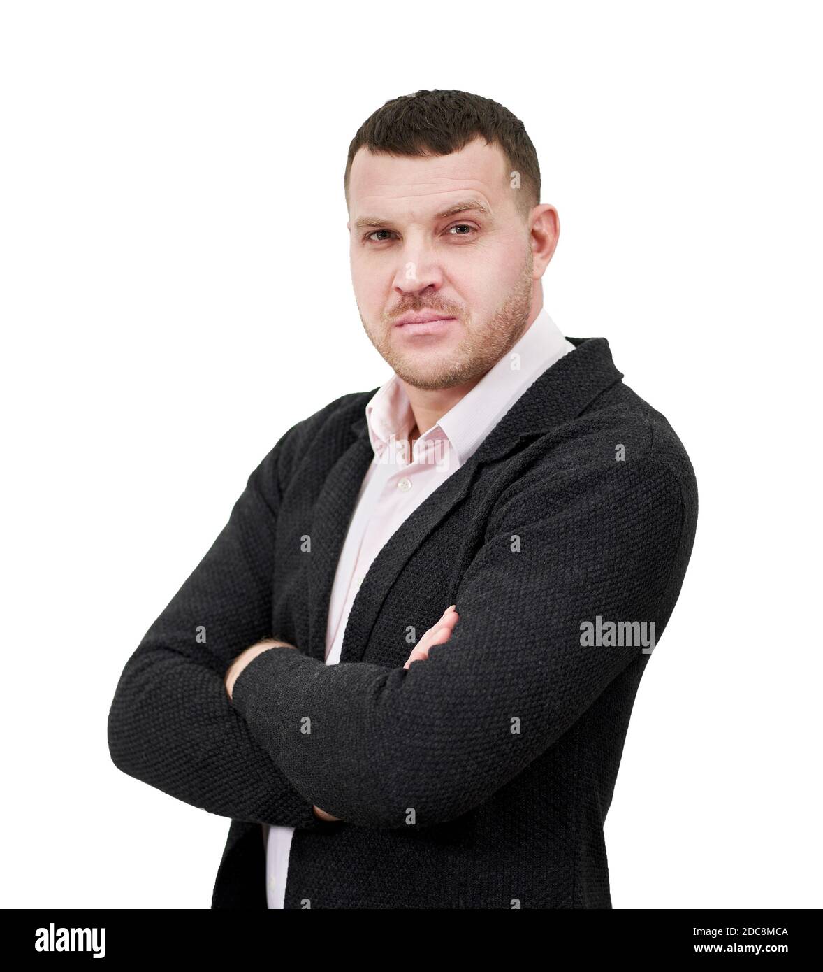 Portrait of an elegant young businessman standing with arms crossed ...