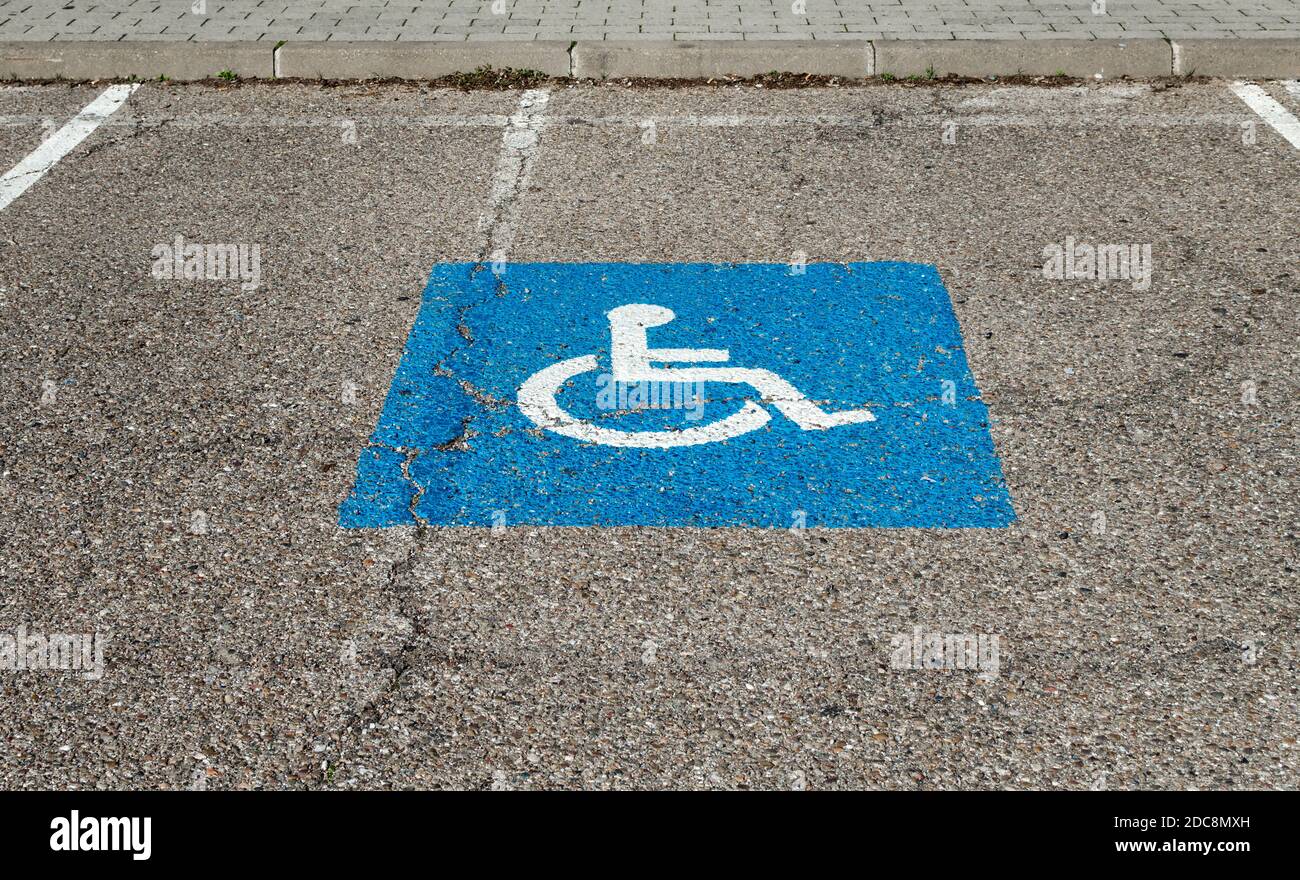 Blue parking sign of a wheelchair for disabled drivers or passengers Stock Photo