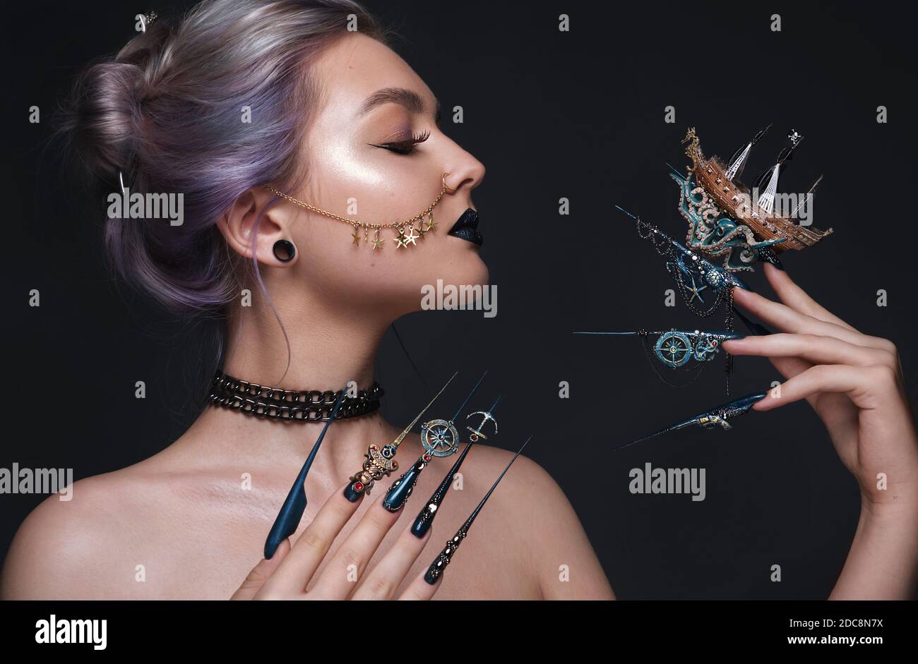 Beautiful girl with art make up in pirate style, creative long nails. Design manicure. Beauty face. Stock Photo