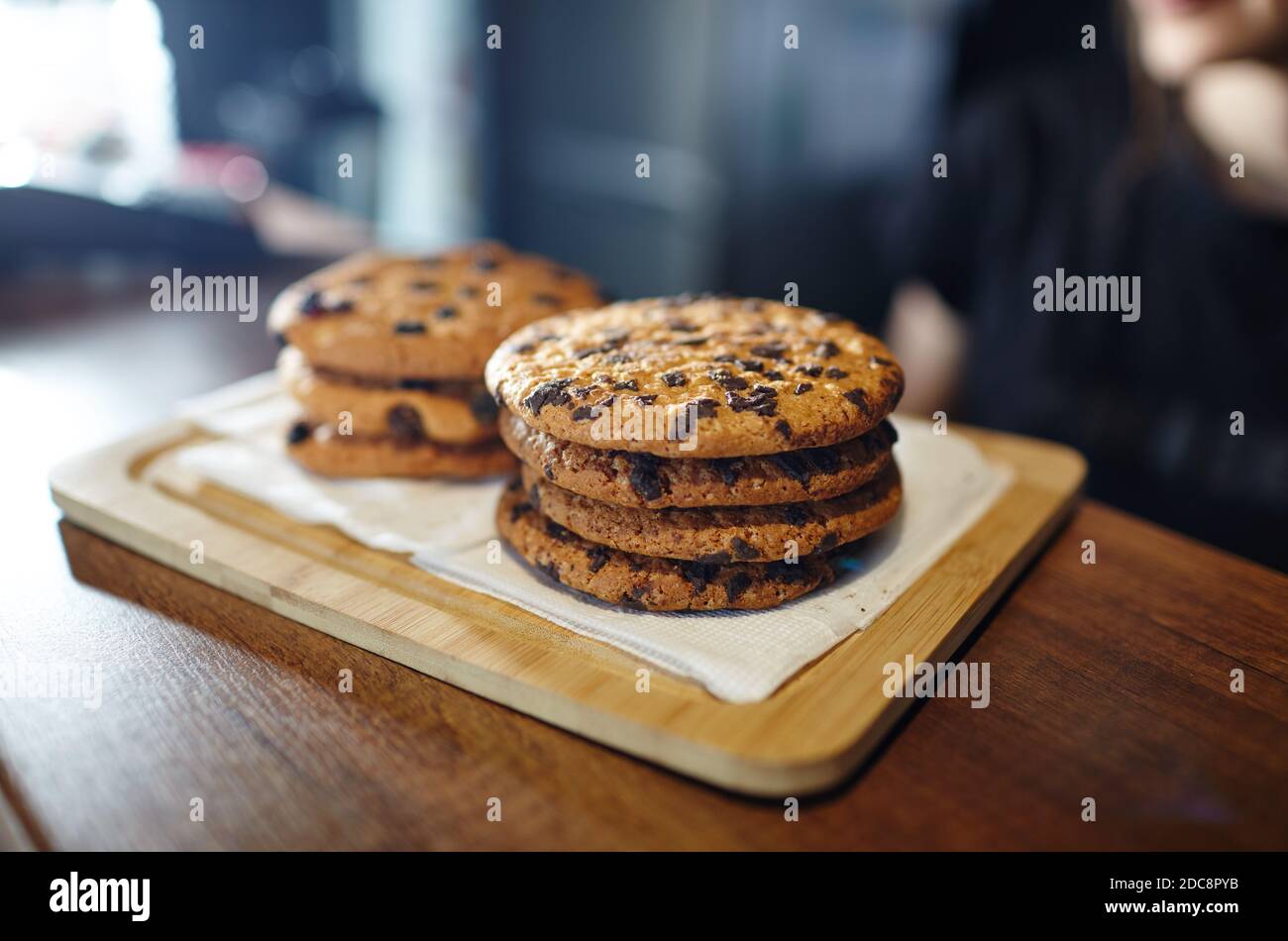 Tasty cookie at bar counter in coffee shop. Blurred image, selective focus Stock Photo
