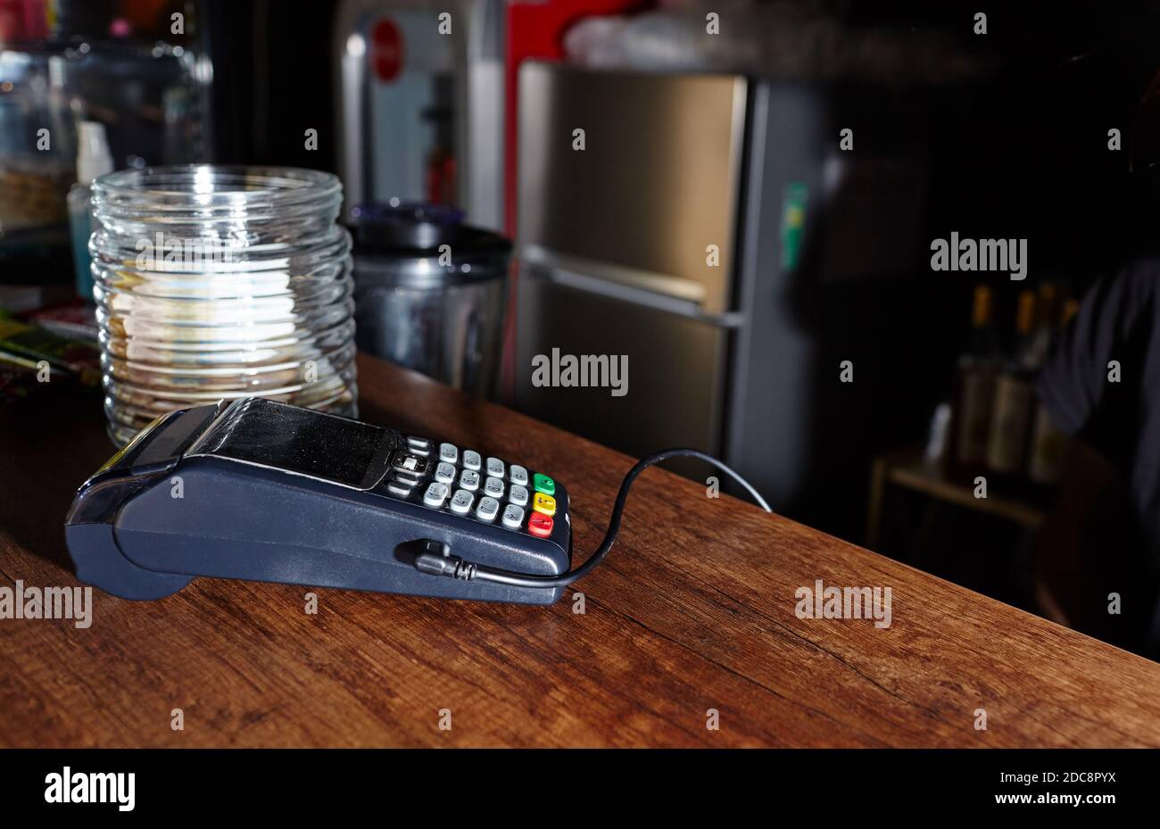 The credit card payment terminal is on the table in coffee shop cafe. Closeup of contactless