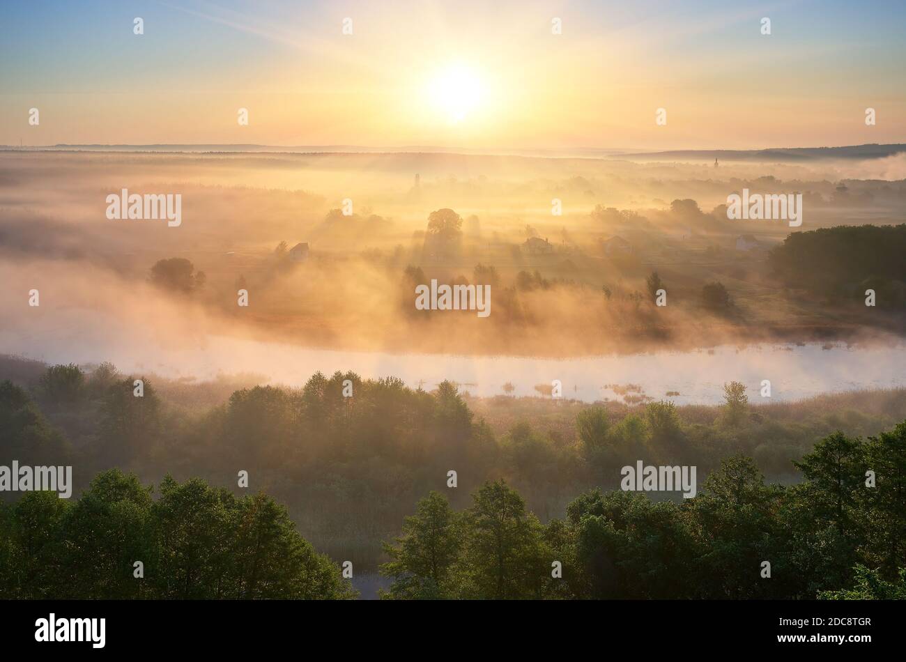 Summer landscape with fog over the river. The first rays of the rising ...