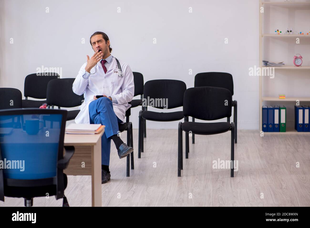 Stressed young man doctor giving hi-res stock photography and images ...