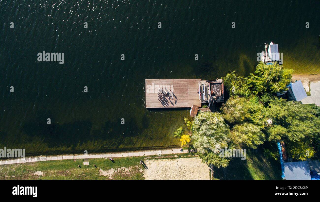 people stand at pier of yacht club, aerial shooting from drone Stock Photo