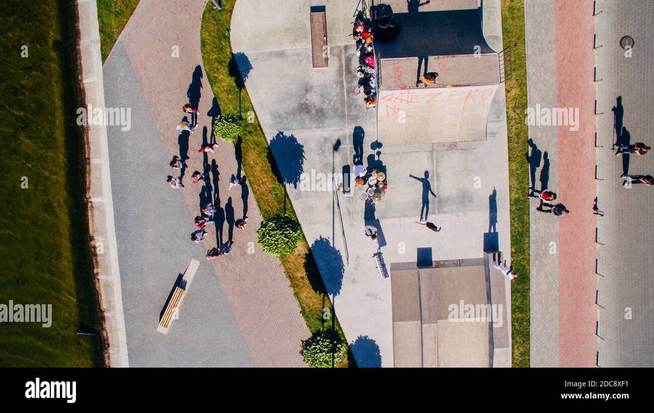 Young people dancing, singing and playing sports on the city s waterfront, aerial shooting from drone. Surrealism Stock Photo