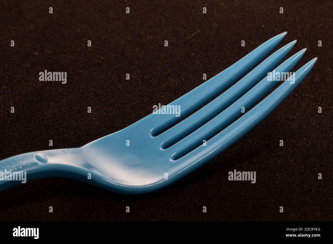 closeup of Colorful plastic eating utensils with dark background Stock