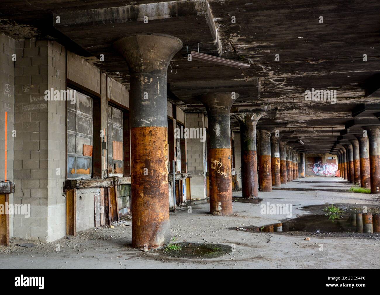 Old and abandoned warehouse loading docks that are falling apart and desolate Stock Photo