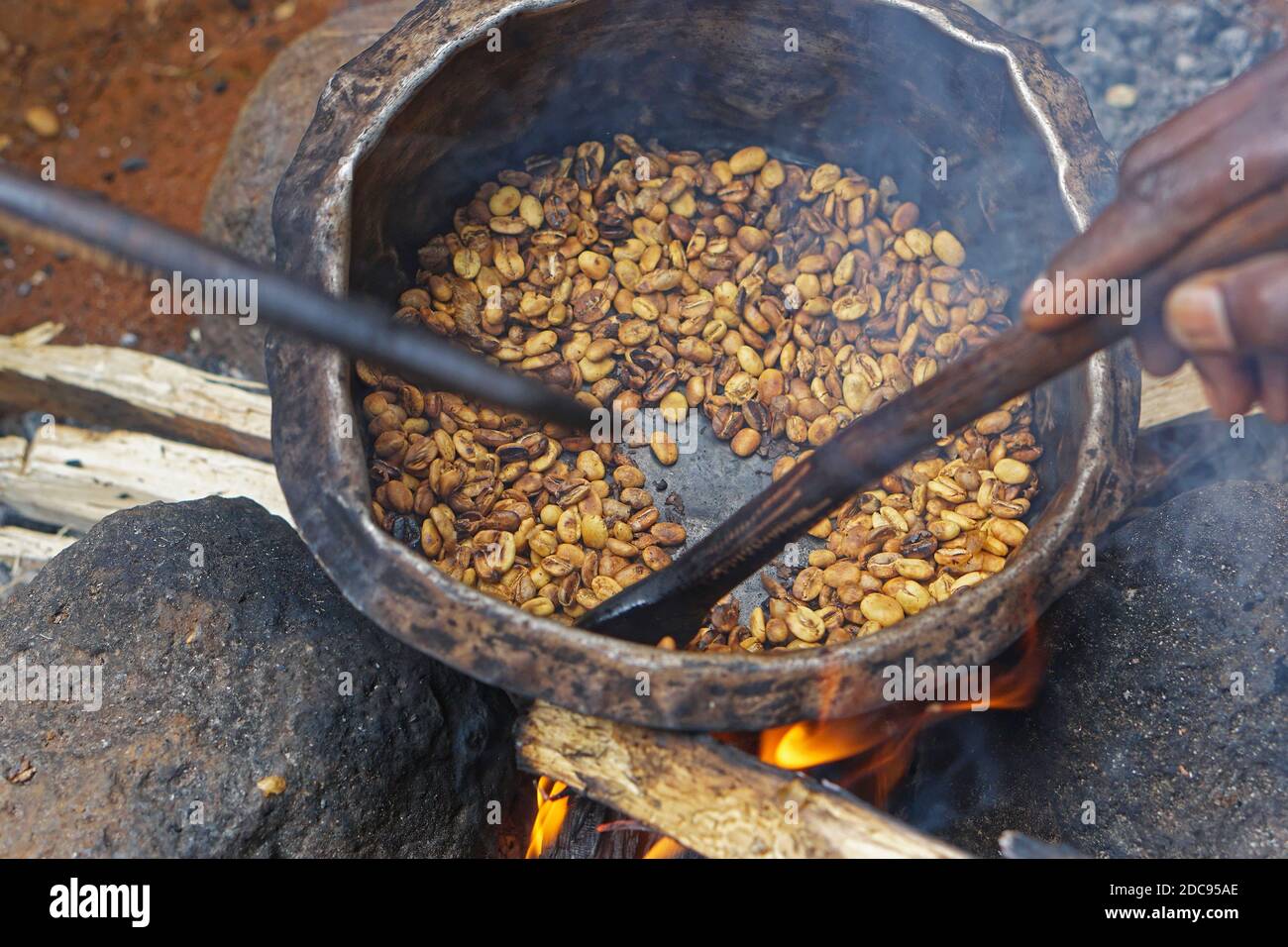 Roasting coffee beans in pot over open fire Stock Photo Alamy