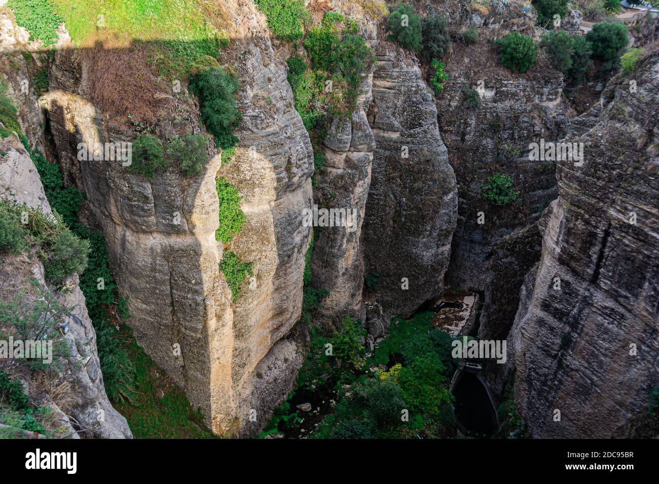 Beautiful canyon view with shadow of the new bridge. Ronda Spain Stock Photo