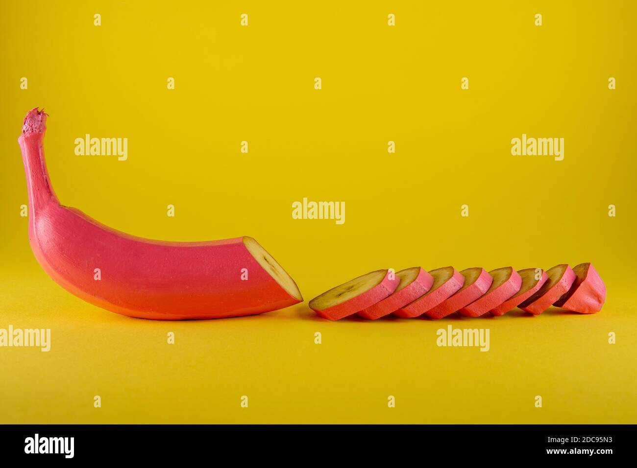 Pink banana on yellow background. Minimal food concept Stock Photo