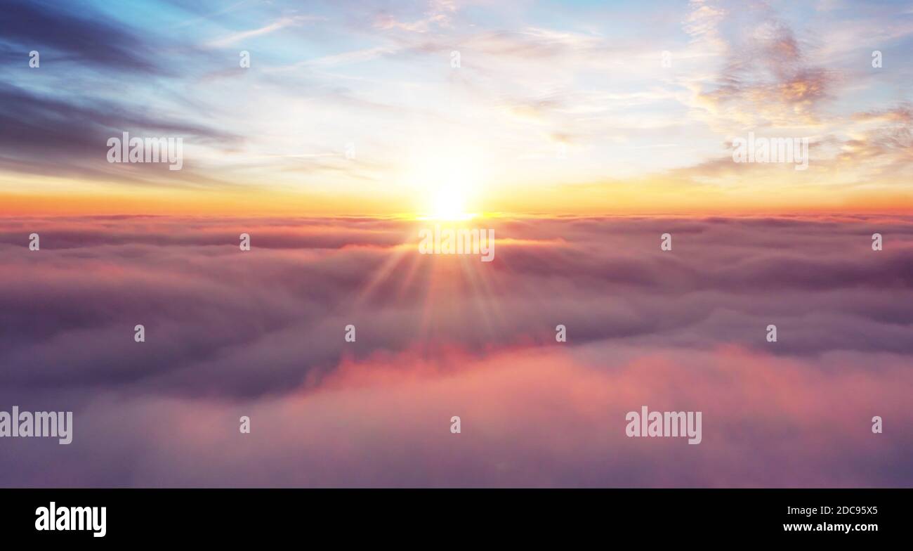 Rising sunset above the clouds, airplane view above the sky Stock Photo