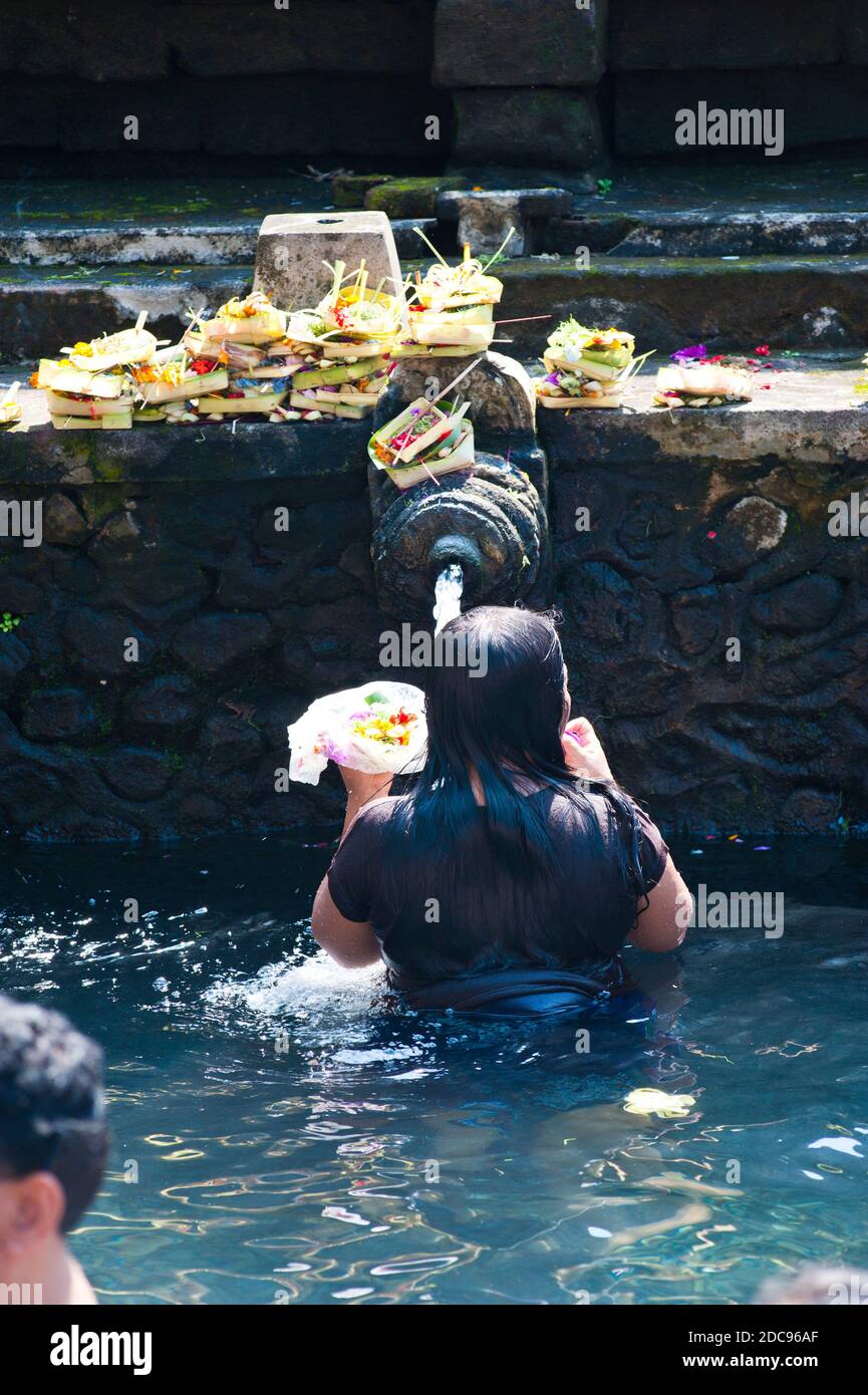 Balinese Woman Washing in Holy Spring Water in the Sacred Pool at Pura Tirta Empul Temple, Bali, Indonesia, Asia Stock Photo