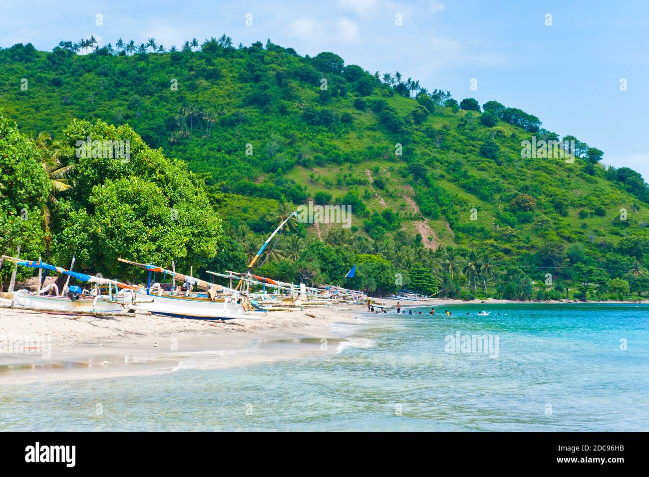 Group of People Swimming at Nippah Beach on Lombok, a Tropical Island in West Nusa Tenggara, Indonesia, Asia Stock Photo