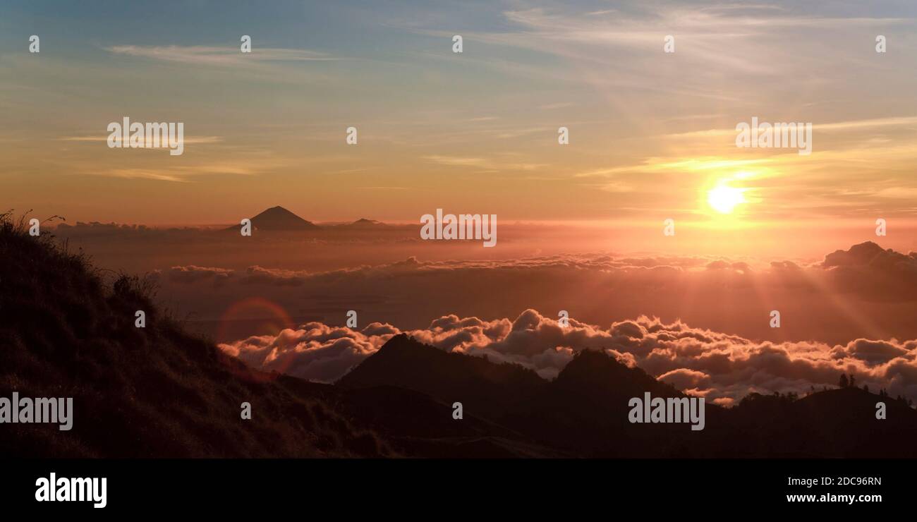 Sunset on the First Day Climbing Mount Rinjani with Mount Agung in the Distance, Lombok, Indonesia, Asia Stock Photo