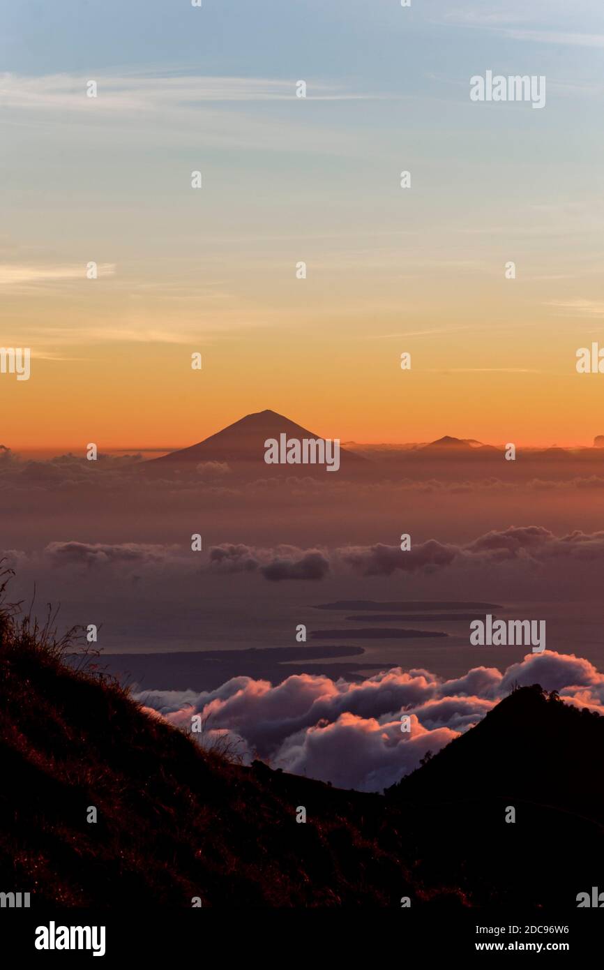 Sunset View over Mount Agung and Mount Batur on Bali, and the Three Gili Isles on the Three Day Mount Rinjani Trek, Lombok, Indonesia, Asia, background with copy space Stock Photo