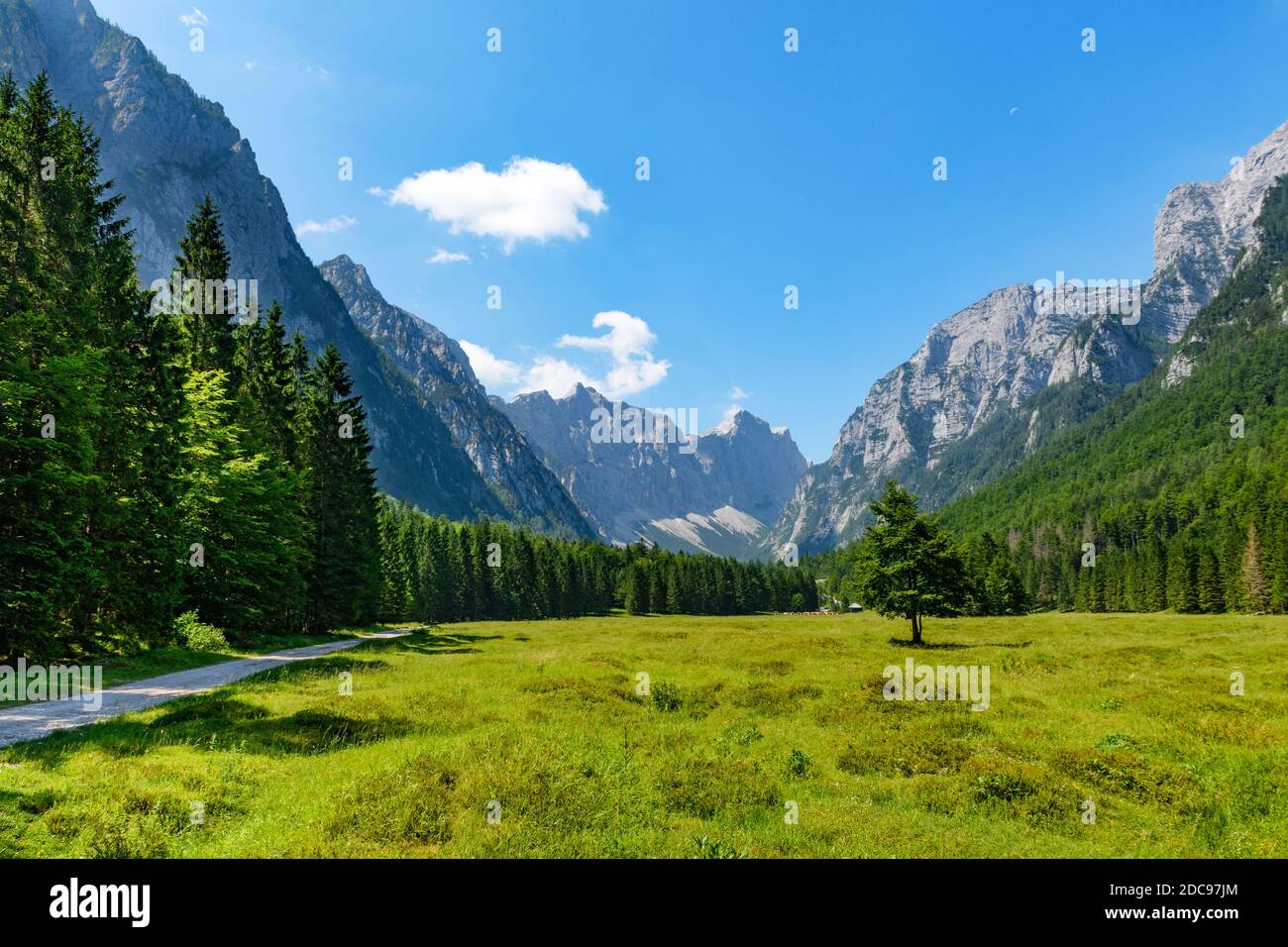 A beautiful mountainous landscape with greenery under a cloudy sky ...