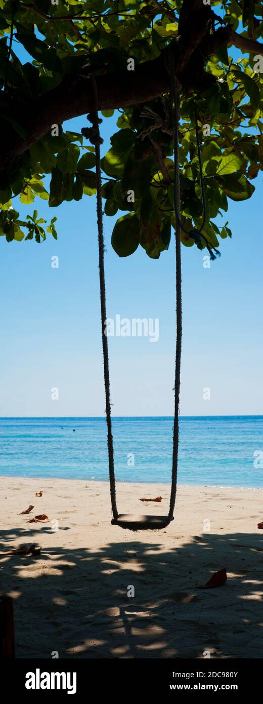 Vertical Panoramic Photo of a Swing on a Beach on the Island of Gili Trawangan, Indonesia, Asia Stock Photo
