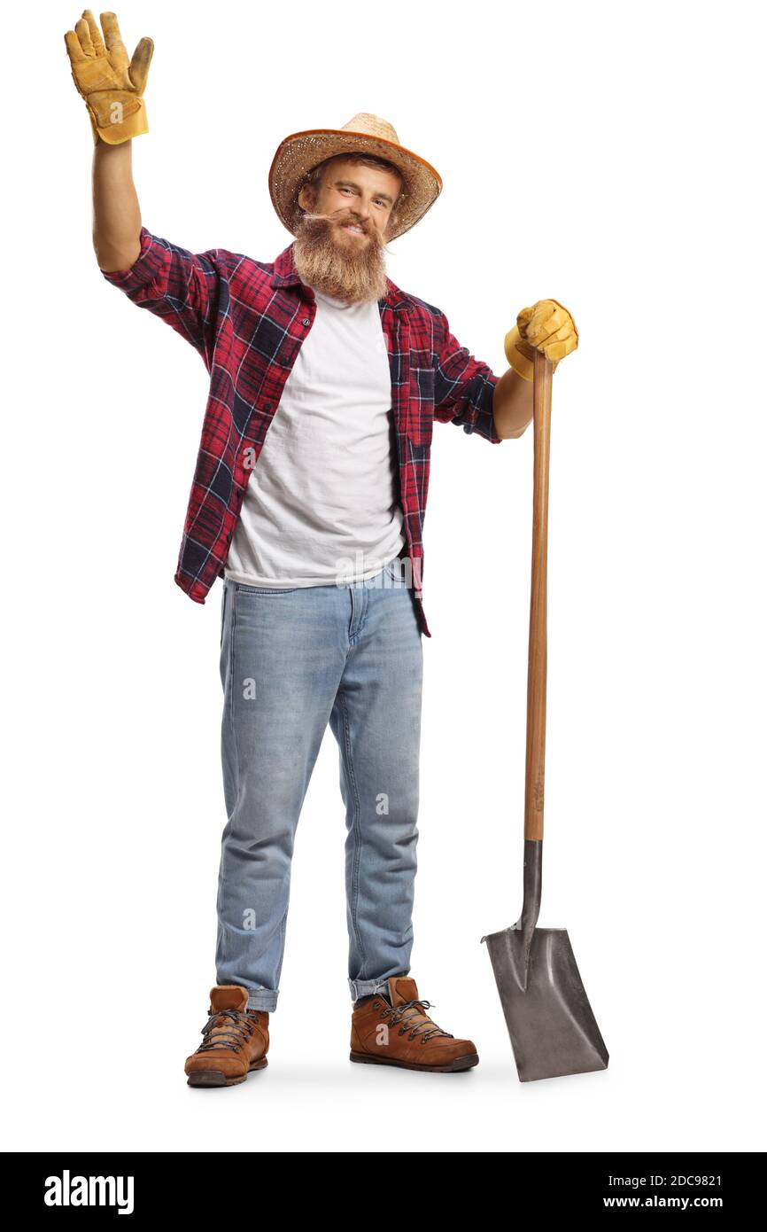 Full length portrait of a bearded farmer with a shovel waving at camera ...