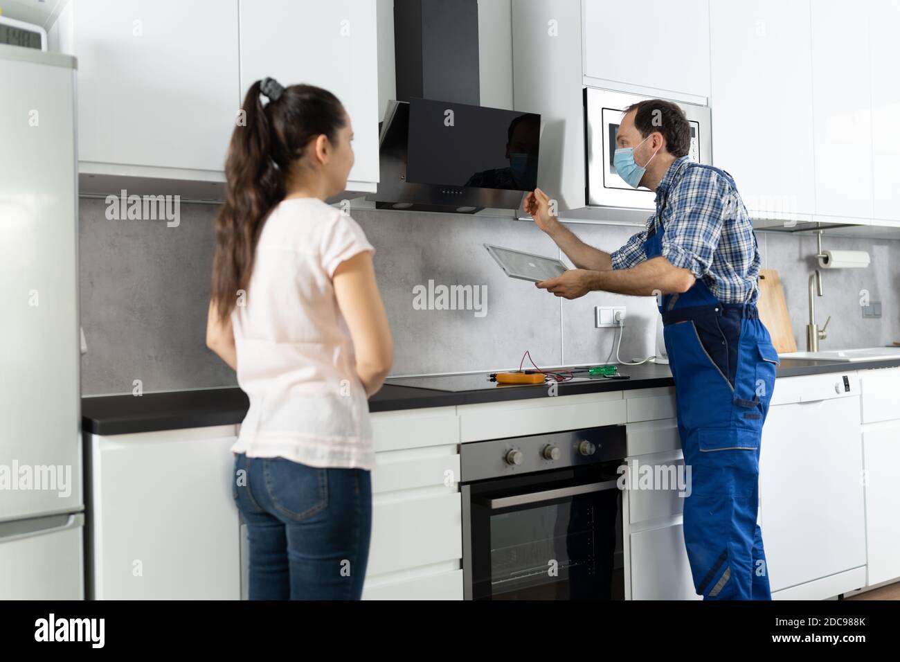 Home Extractor Appliances Installation And Repair In Face Mask Stock Photo