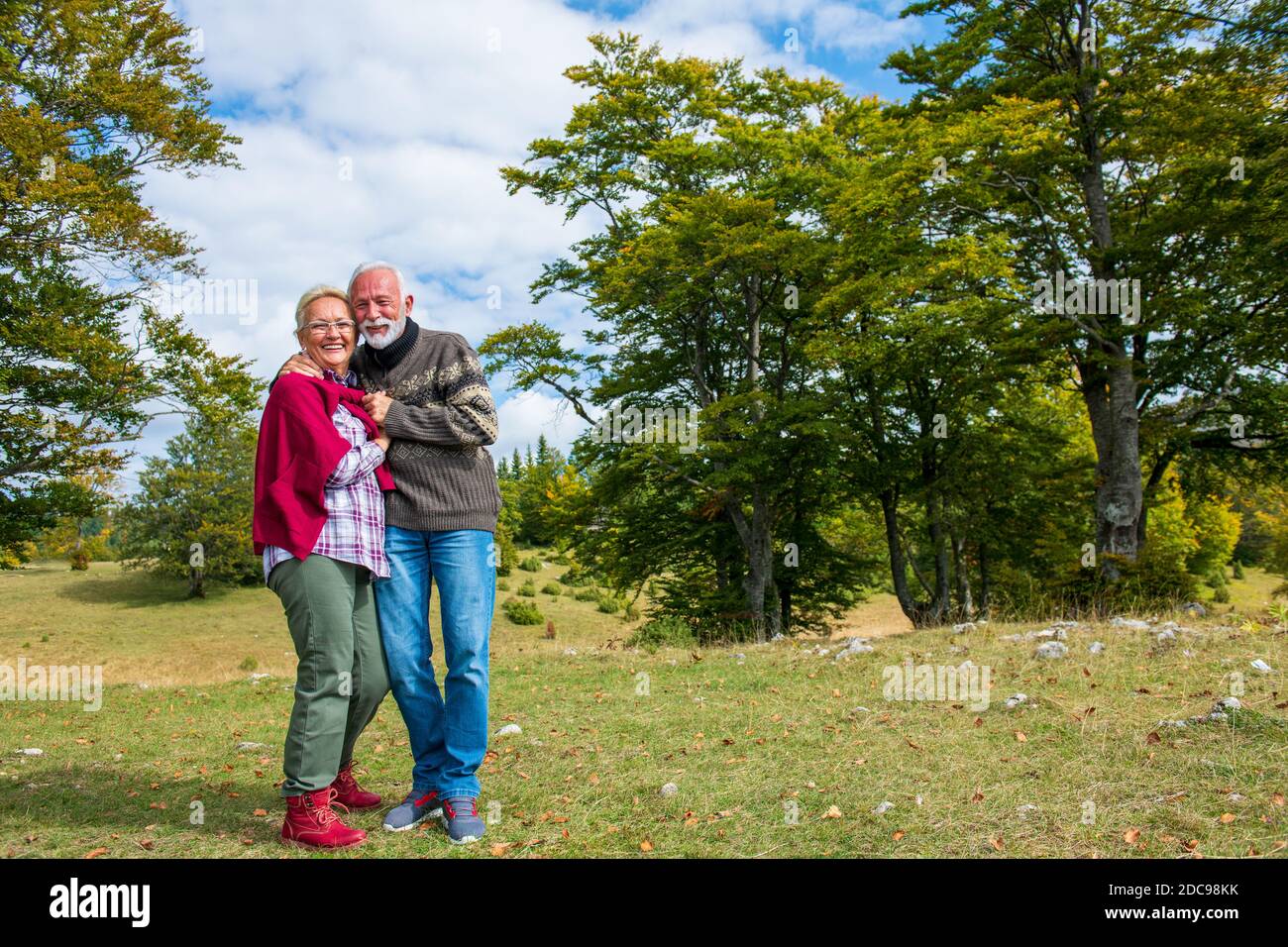 Senior couple on a walk in an autumn nature Stock Photo - Alamy