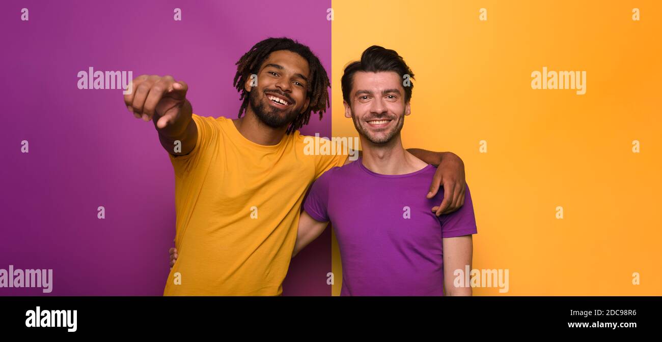 Blank and white friends. Concept of integration, union and partnership. Yellow and violet background Stock Photo