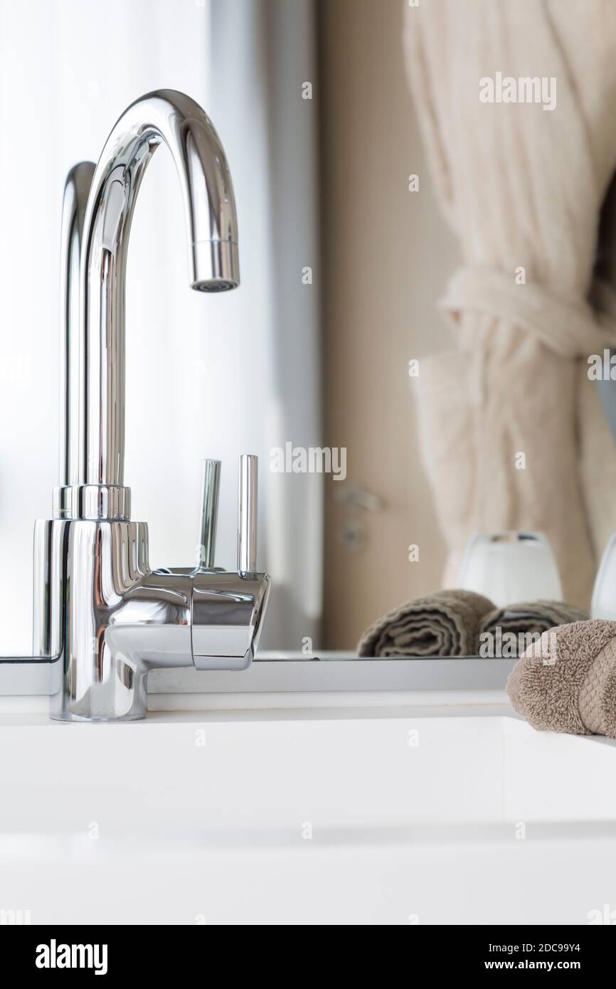 Contemporary bathroom sink, closeup of wash basin and mixer tap, UK Stock Photo