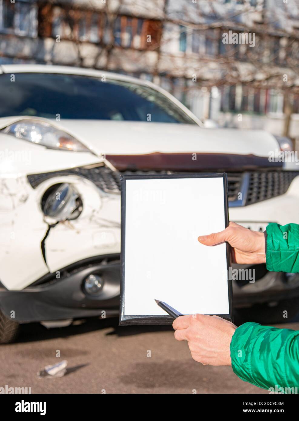 Space for text, blank document close up. An insurance agent will inspect and inspect vehicle damage after an accident. Inspection of the car after an Stock Photo