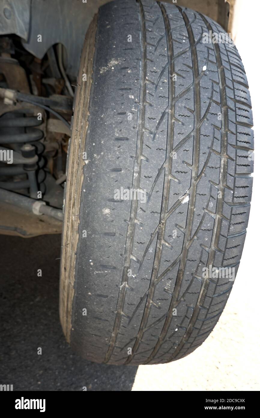 Uneven tire wear due to incorrect wheel alignment on a Ford F150 Stock