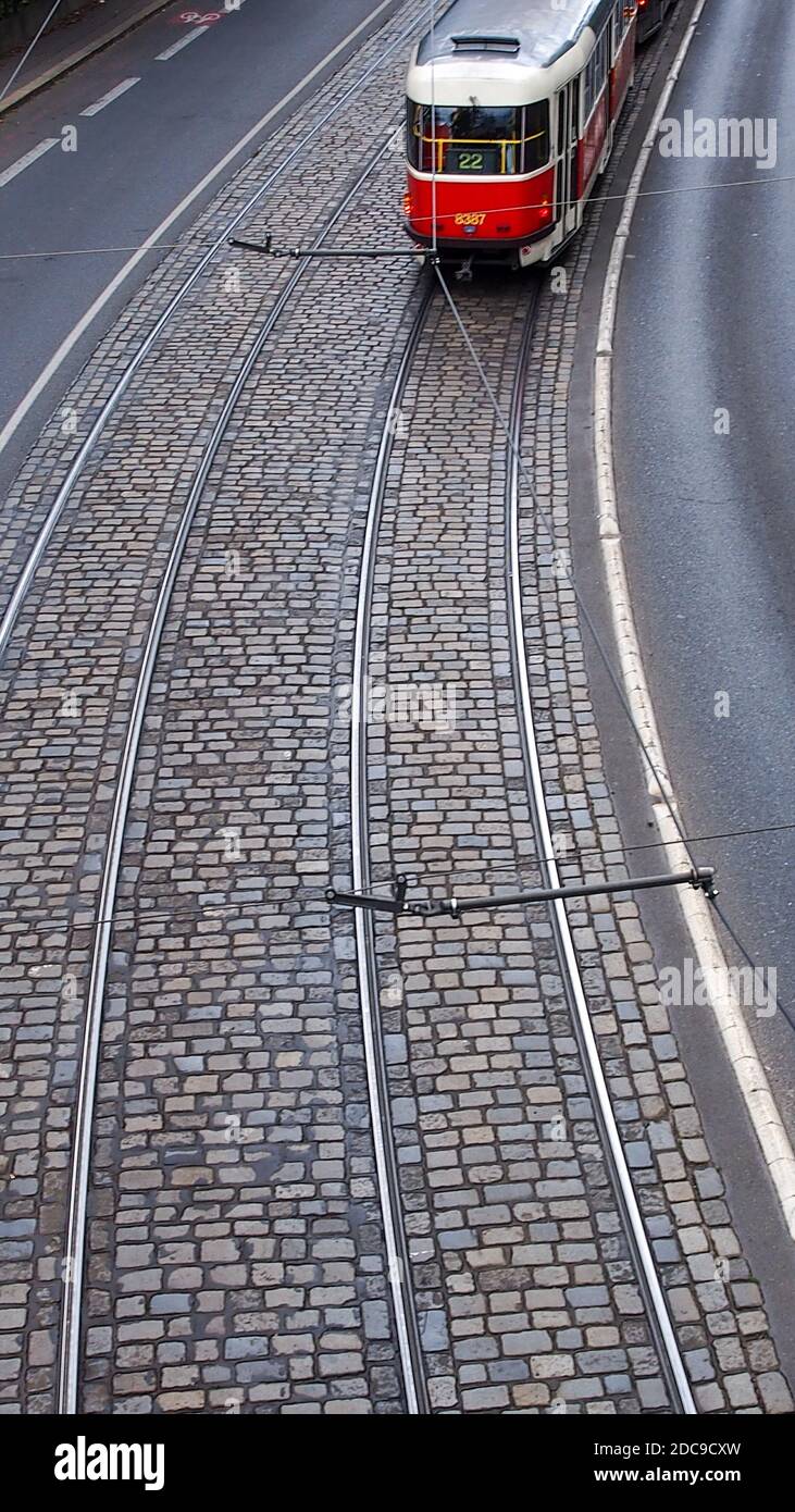 high angle view of vintage public train transportation through old city cobblestone streets Stock Photo