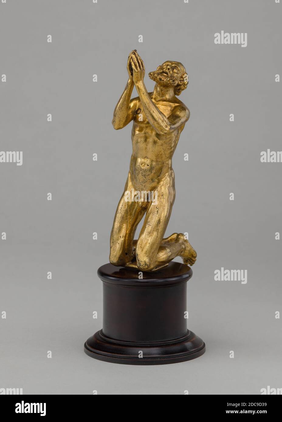 Spanish 16th Century, (sculptor), Kneeling Supplicant, 16th century, gilded bronze, overall: 10.3 x 3.2 x 6.1 cm (4 1/16 x 1 1/4 x 2 3/8 in Stock Photo