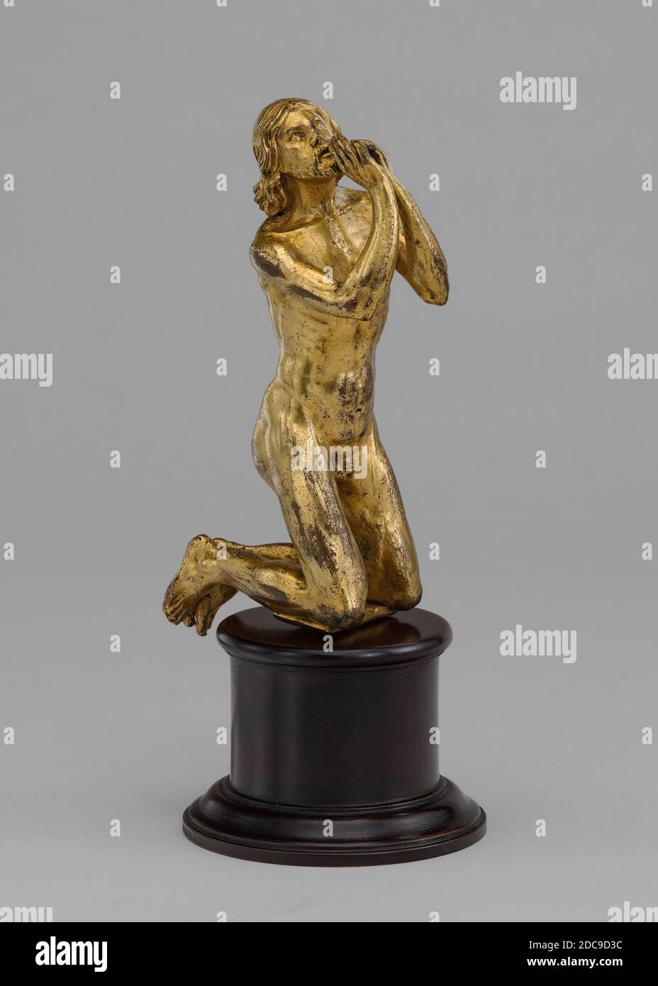 Spanish 16th Century, (sculptor), Kneeling Supplicant, 16th century, gilded bronze, overall: 9.8 x 3.2 x 4 cm (3 7/8 x 1 1/4 x 1 9/16 in Stock Photo