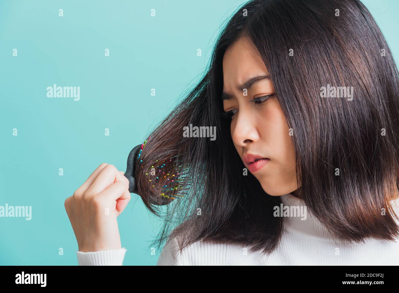 Young beautiful Asian woman upset with a comb and problem hair, Portrait  female shocked suffering from hair loss problem, studio shot isolated on a  bl Stock Photo - Alamy