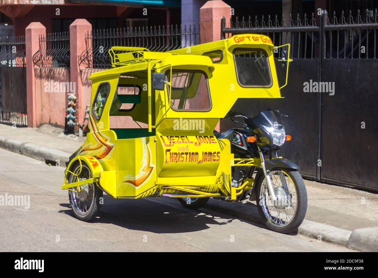 A yellow tricycle, a local passenger vehicle in Biliran, Philippines Stock Photo