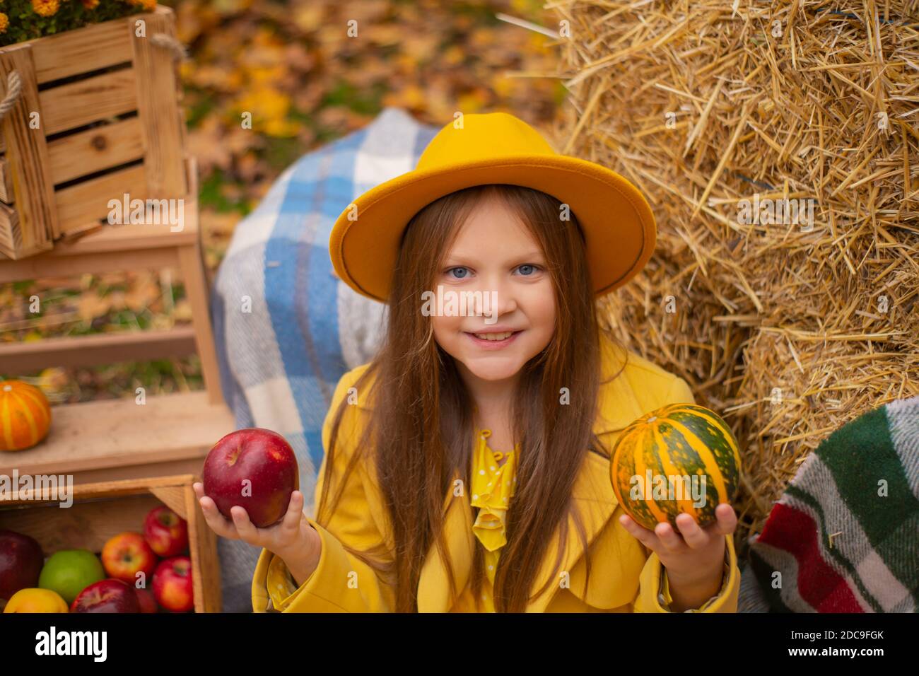 cute beautiful teenage brunette girl in an orange hat, dress and coat ...