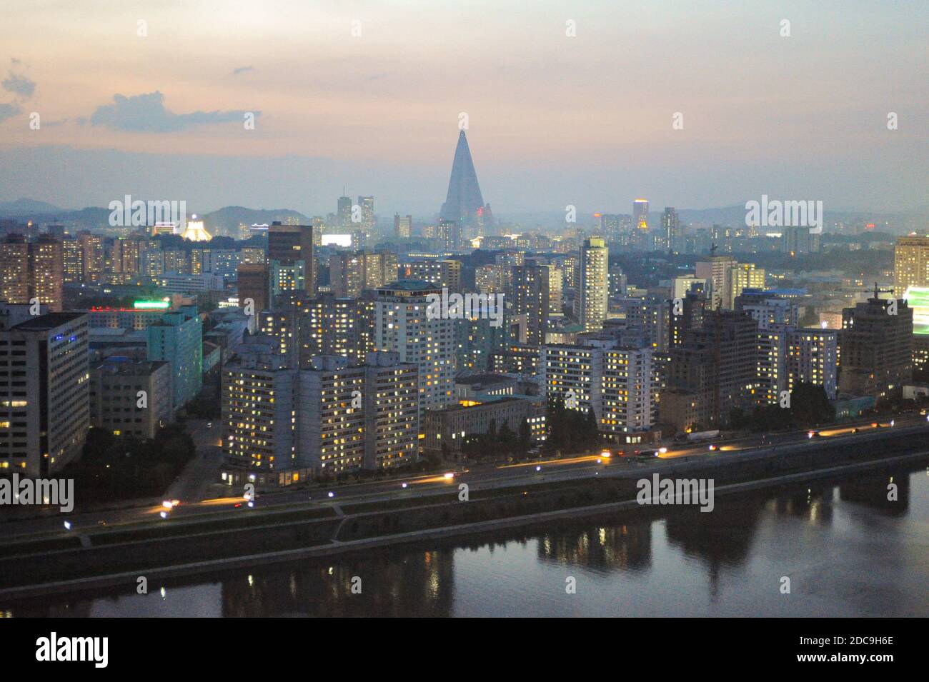 07.08.2012, Pyongyang, , North Korea - Elevated city view with illuminated residential buildings and the Ryugyong Hotel in the center of the North Kor Stock Photo