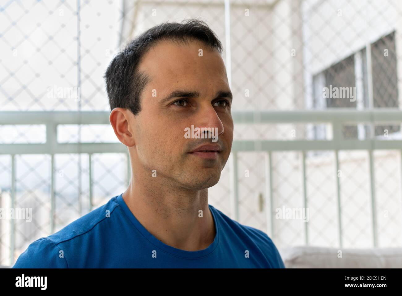 43 year old man in blue shirt looking at the diagonal. Stock Photo