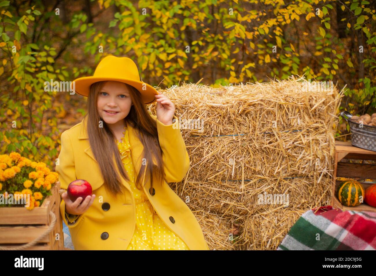 cute beautiful teenage brunette girl in an orange hat, dress and coat ...