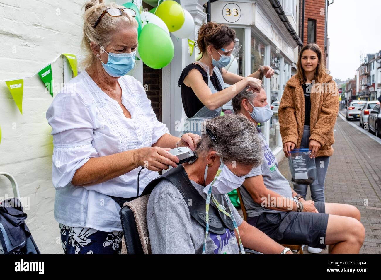 People Having Their Hair Shaved Off To Raise Money For The Macmillan Cancer Care Charity, High Street, Lewes, East Sussex, UK. Stock Photo